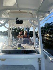 a person waving in a boat